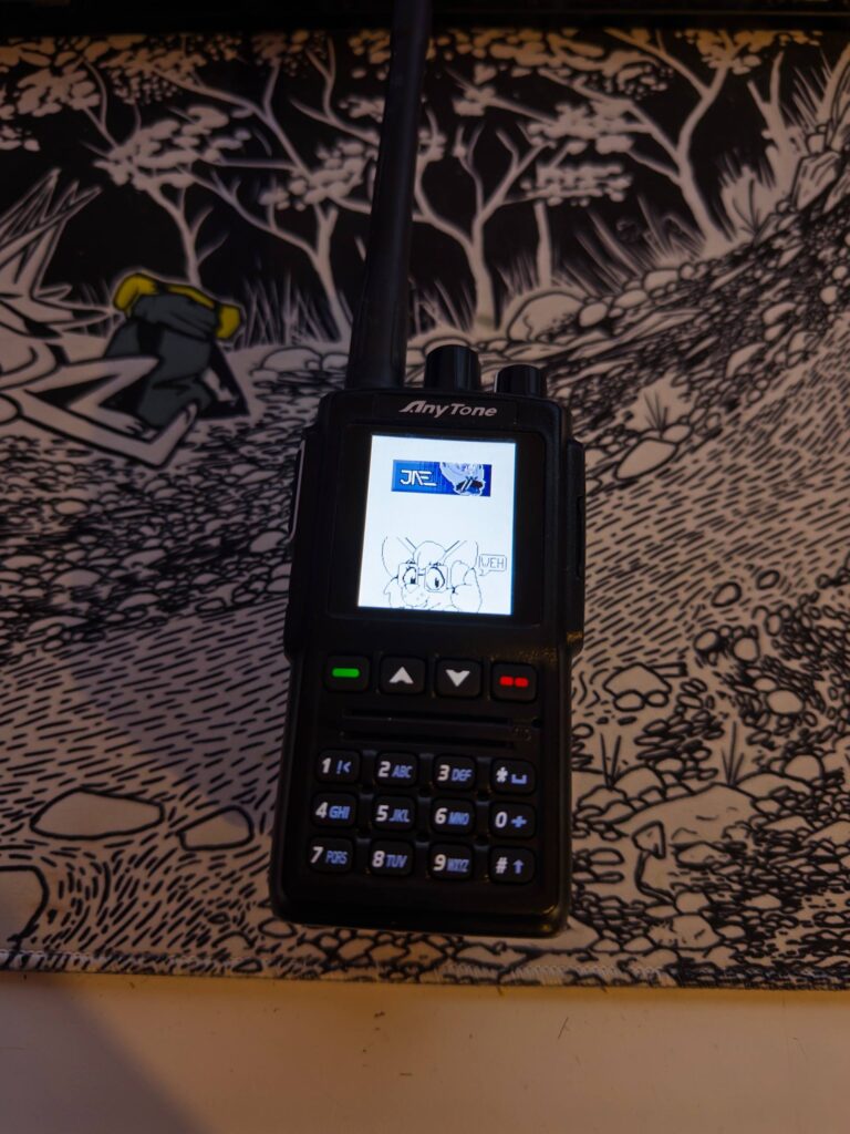 Radio on a desk. Screen is showing a drawing of Jae holding a phone and saying: Weh.
